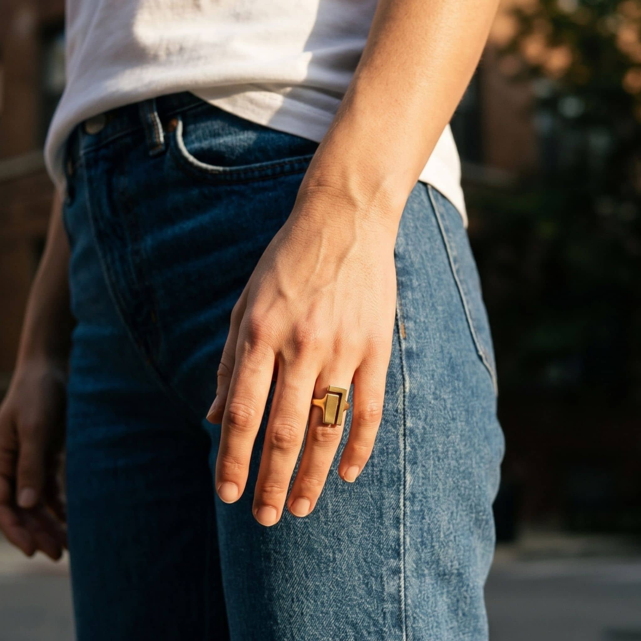 Juzi brass ring worn on hand showing angular face and open band