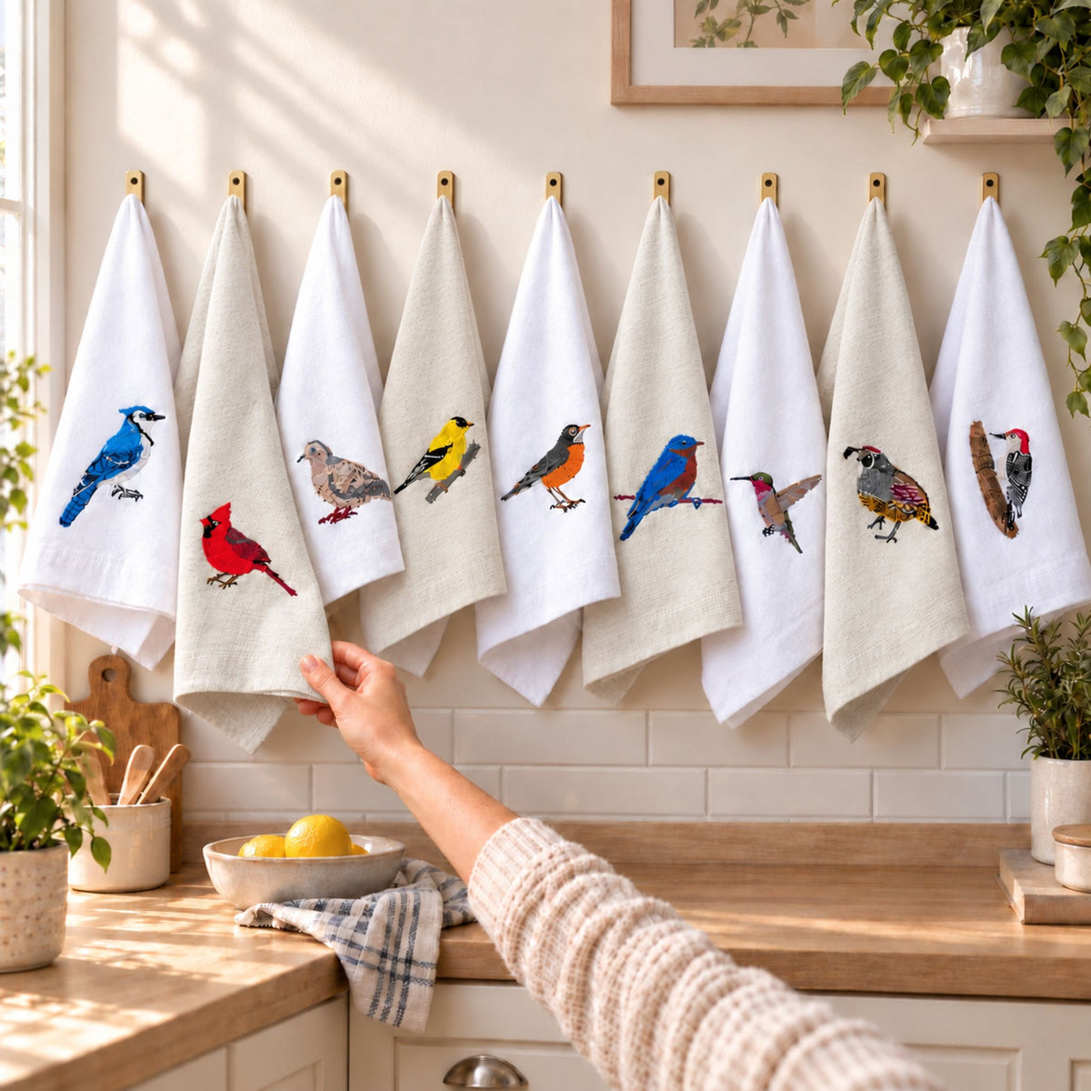 Birds embroidered cotton tea towel flat lay on white surface