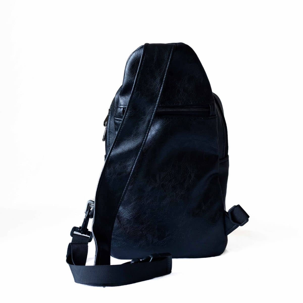 Umoja black vegan leather sling bag worn crossbody