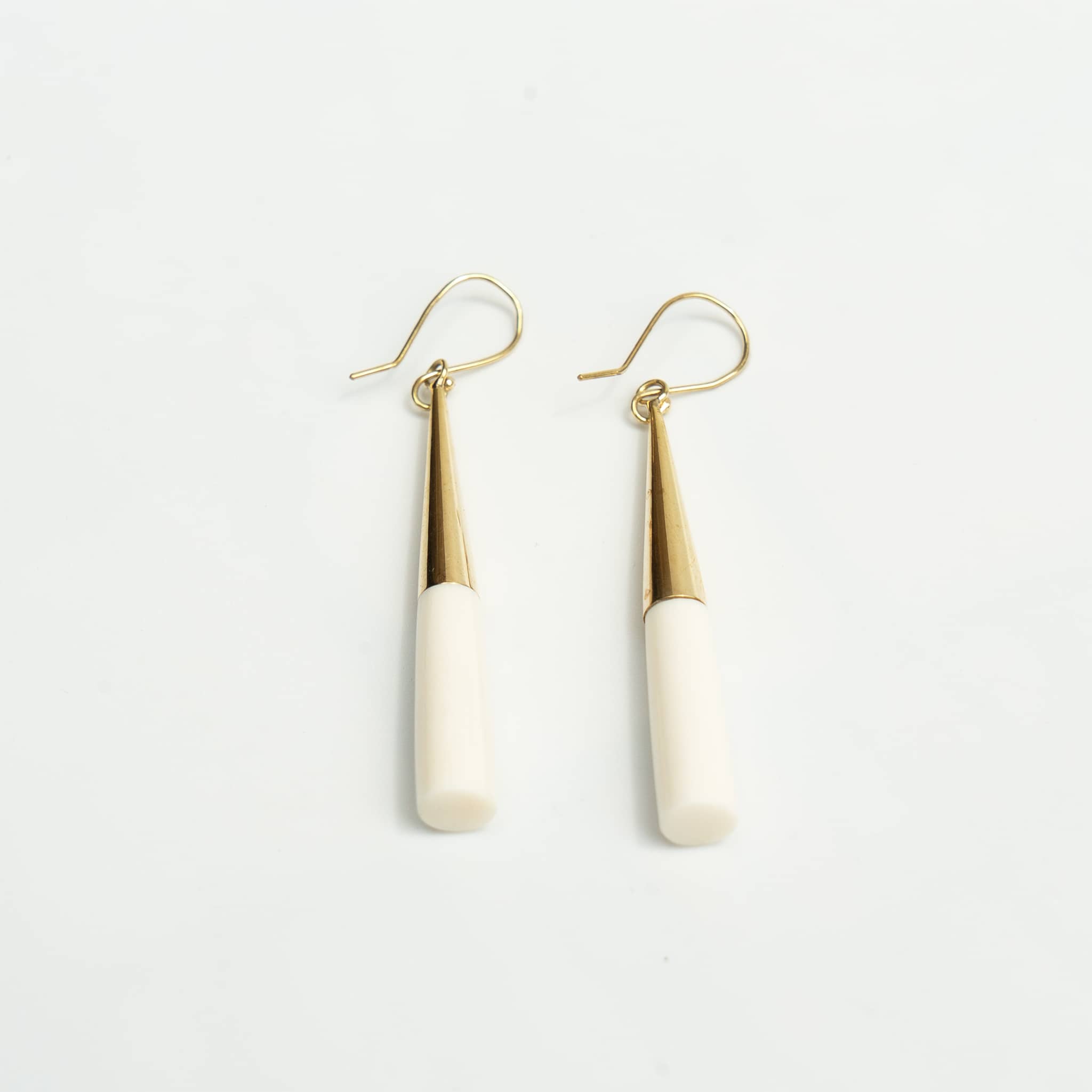 Lulu brass and white horn drop earrings flat lay — Ecodunia