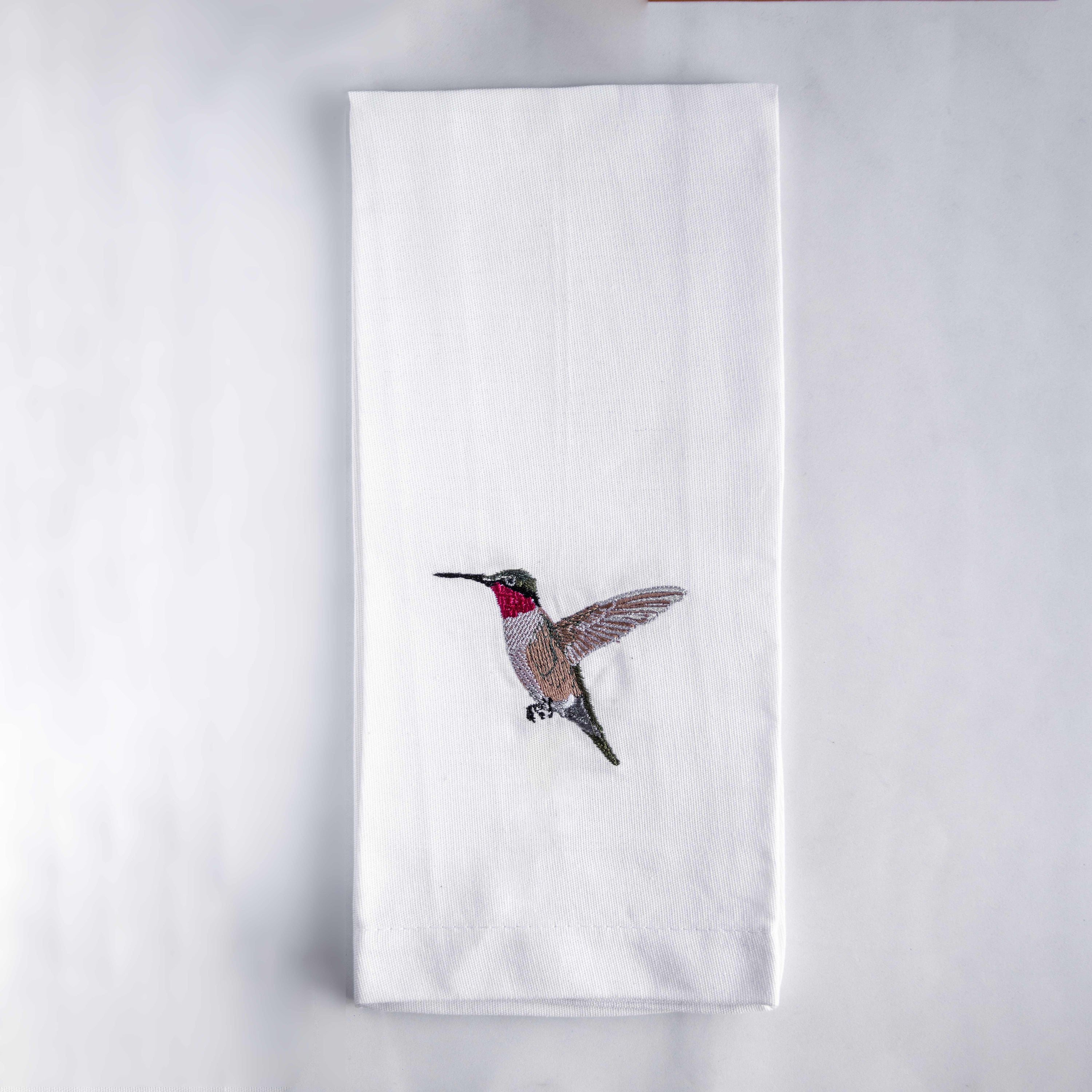 Humming bird embroidered cotton tea towel flat lay on white surface — Ecodunia