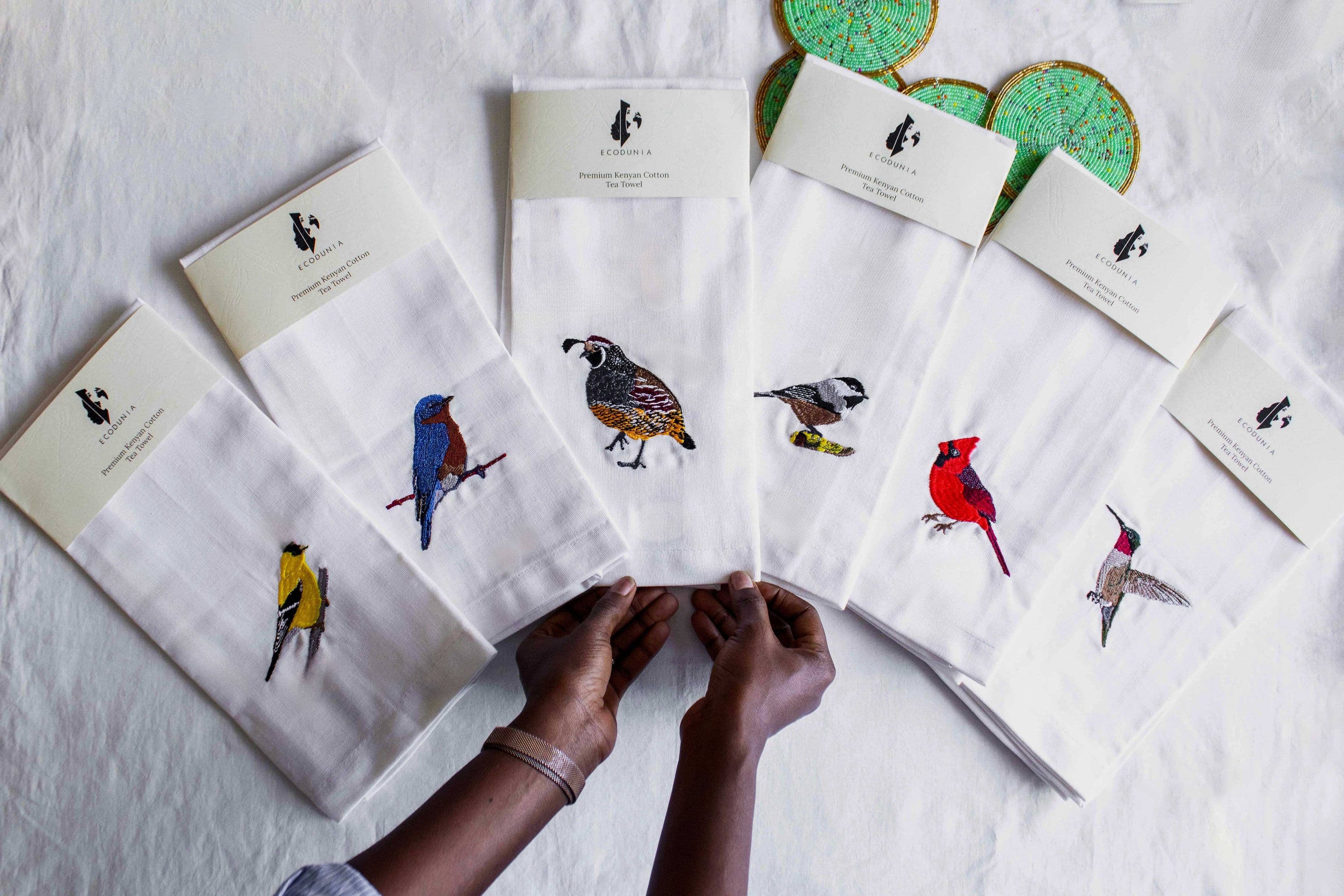 Hummingbird embroidered cotton tea towel flat lay on white surface — Ecodunia