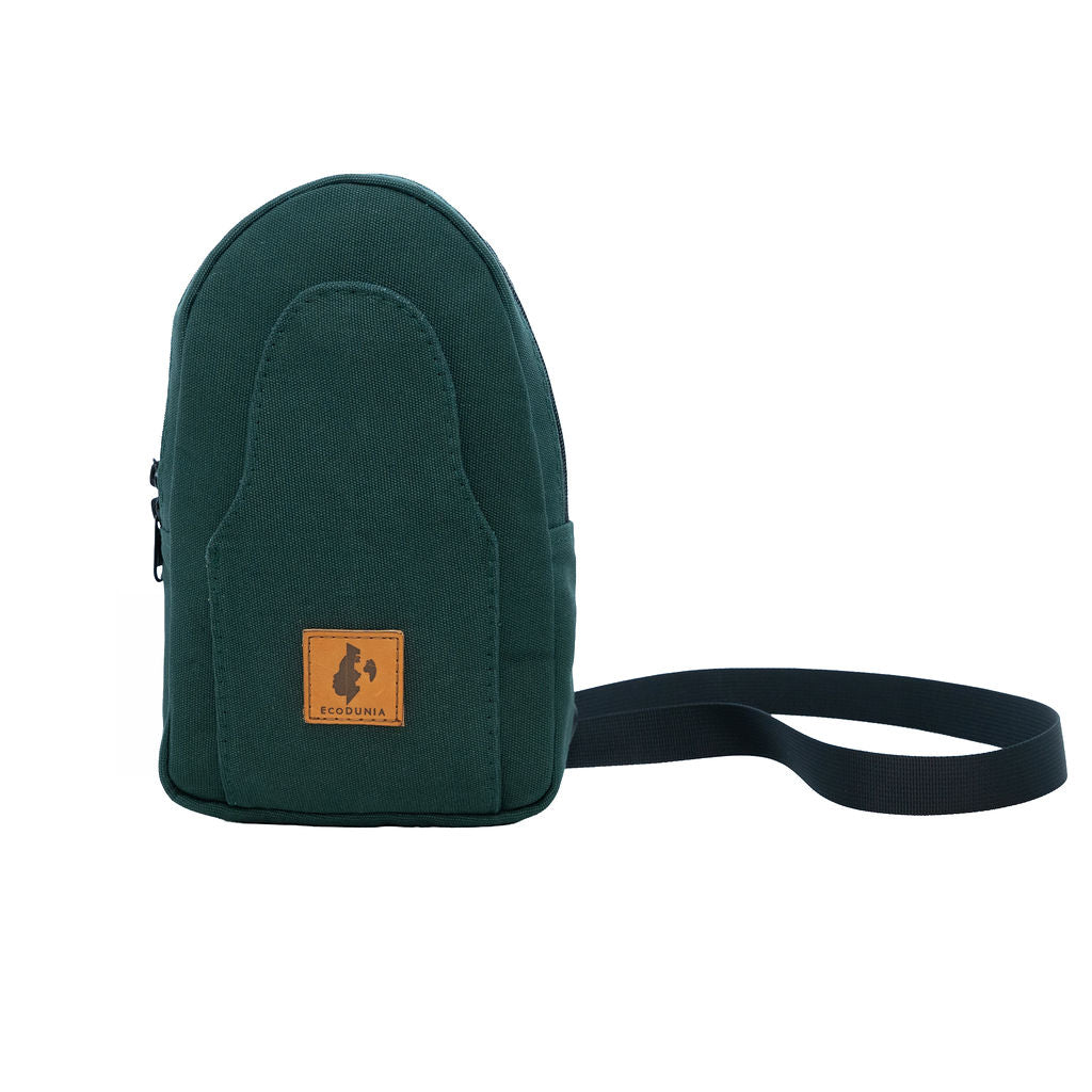 Buru canvas sling bag in forest green worn crossbody