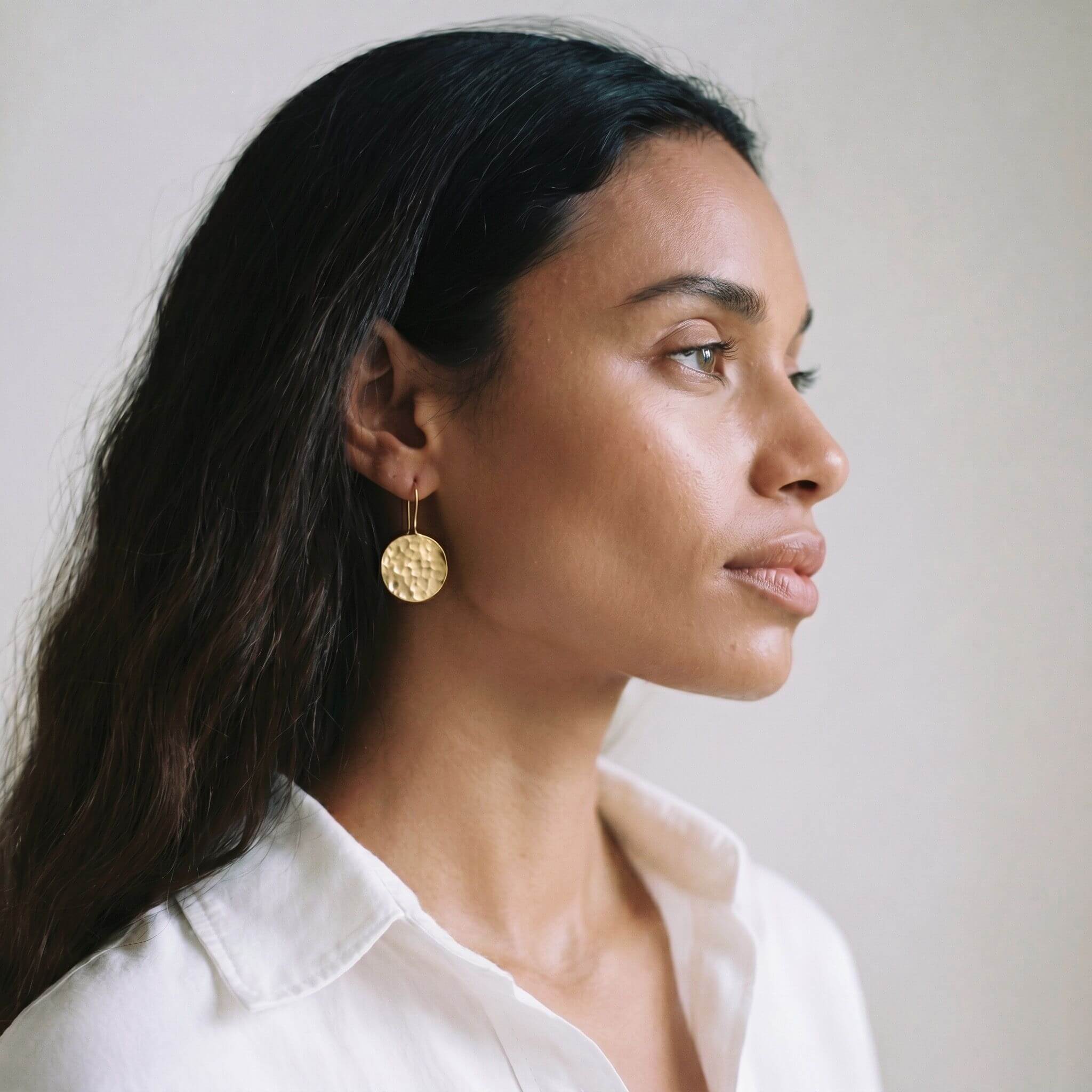 Njiwa hammered disc brass drop earrings flat lay — Ecodunia