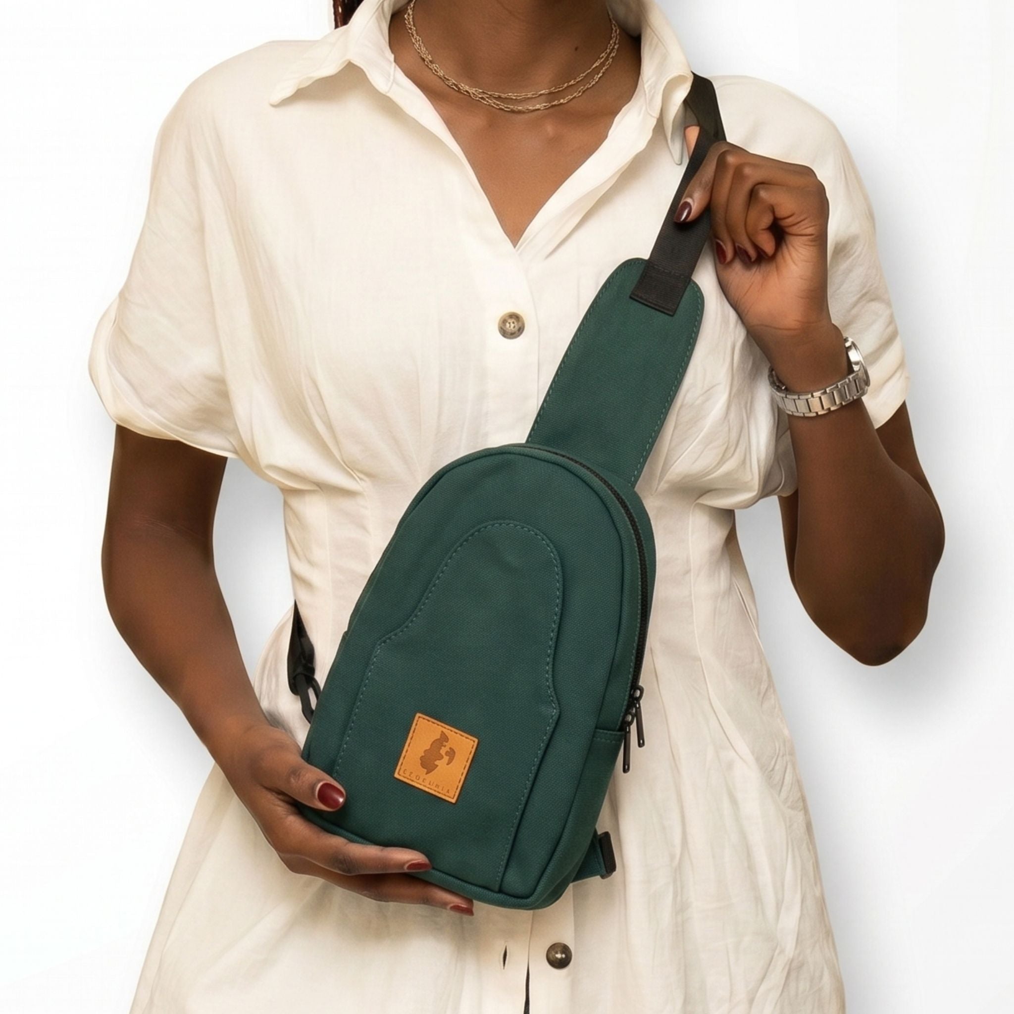 Buru canvas sling bag in forest green worn crossbody