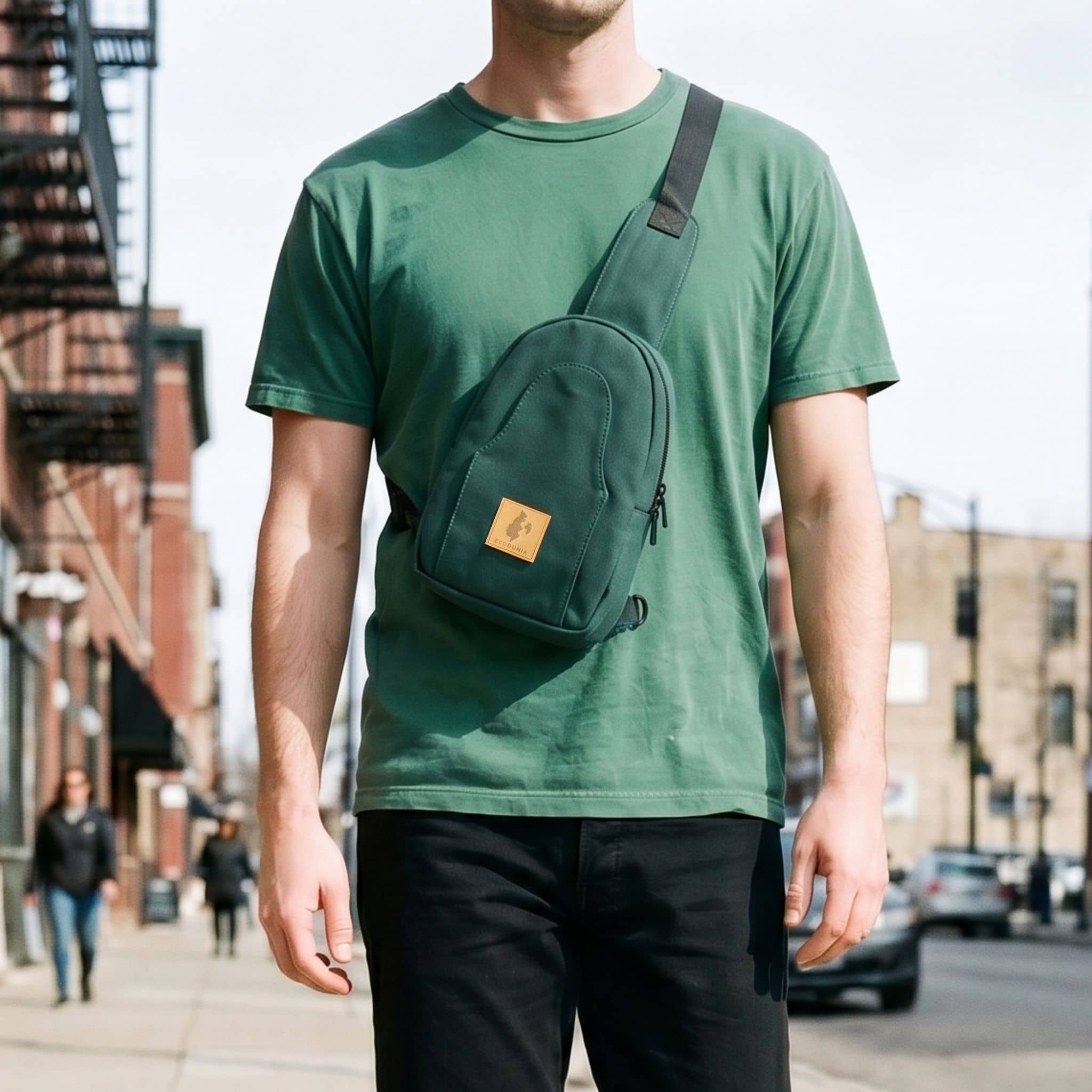Buru canvas sling bag in forest green worn crossbody