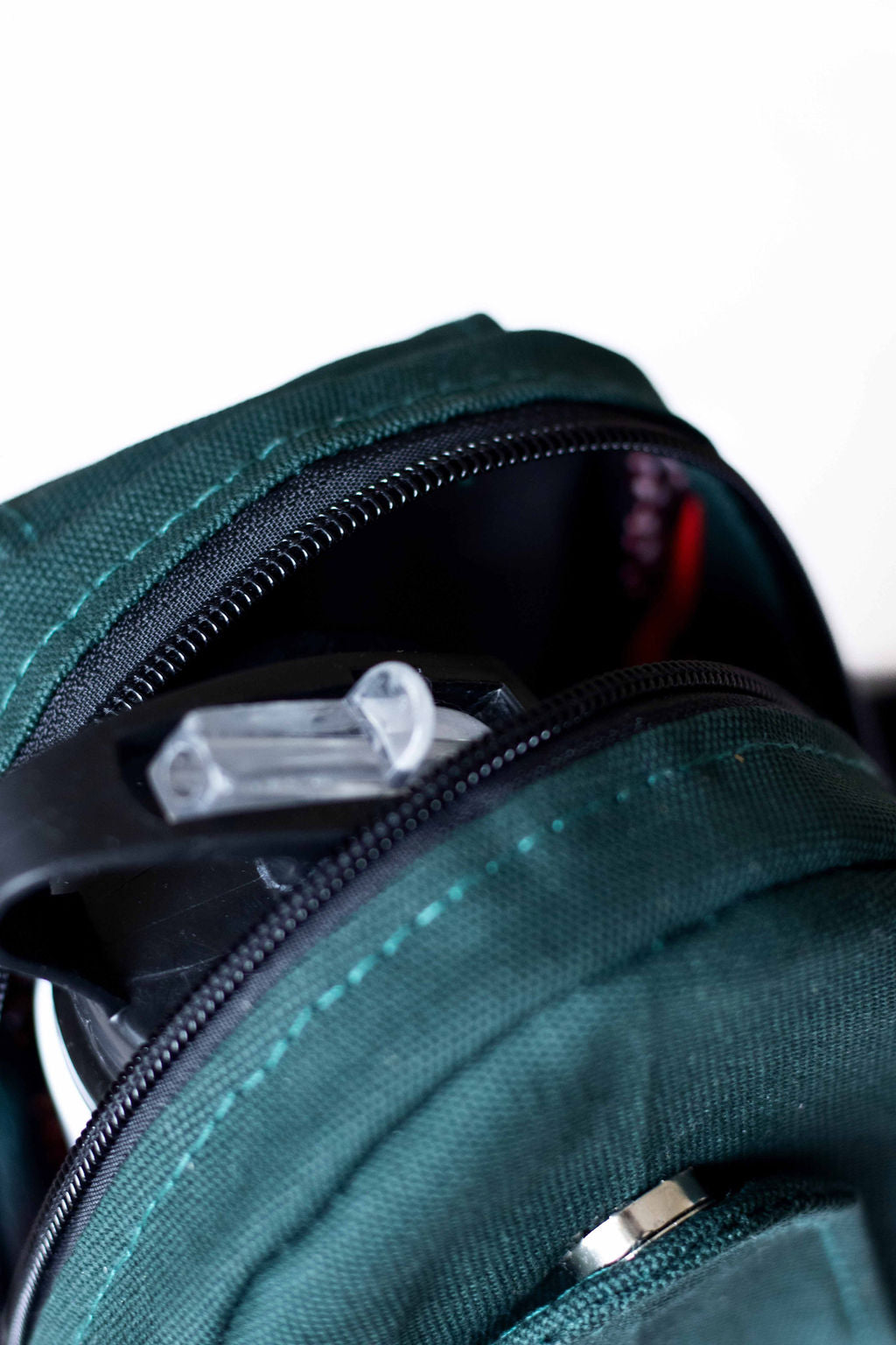 Buru canvas sling bag in forest green worn crossbody