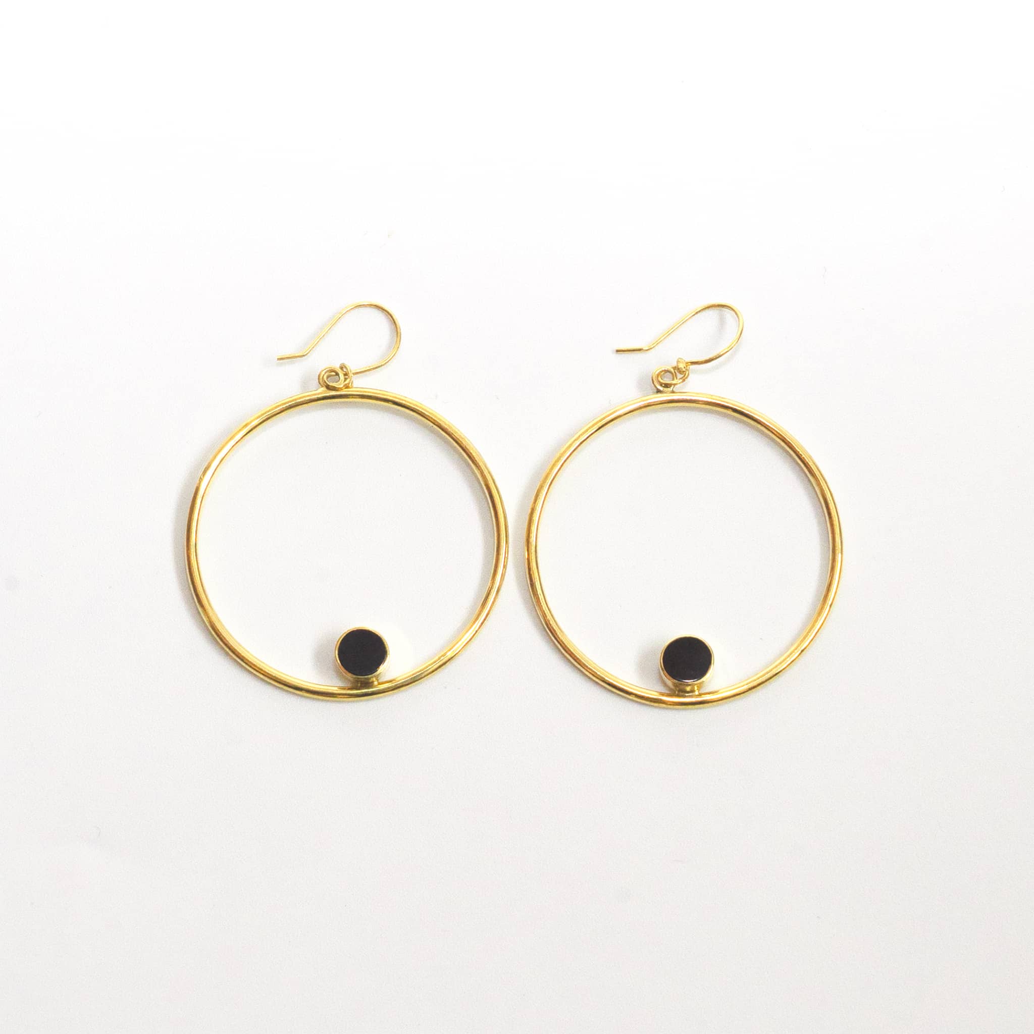 Lozi brass hoop with black horn accent earrings flat lay — Ecodunia