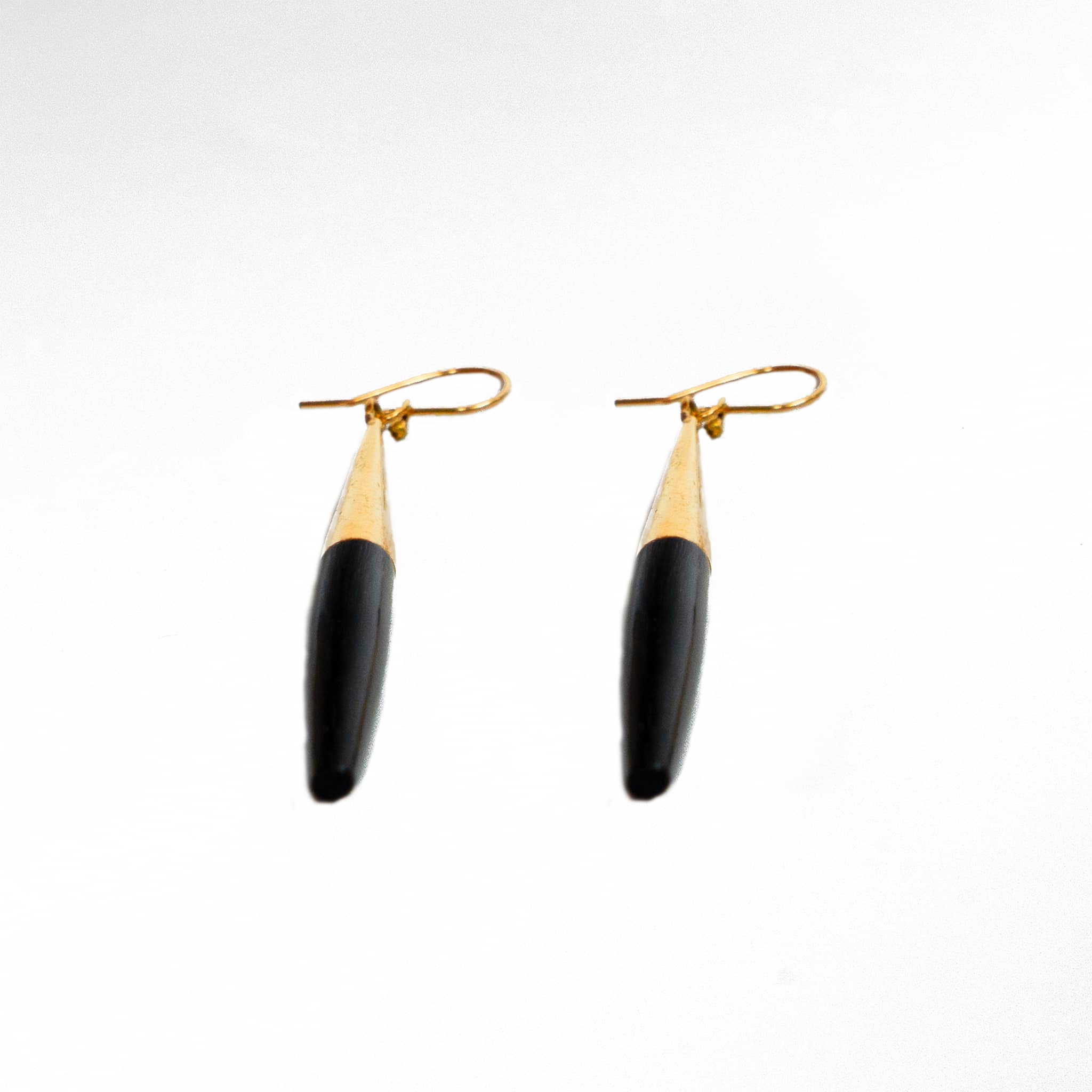 Luna brass and white horn spike drop earrings flat lay — Ecodunia