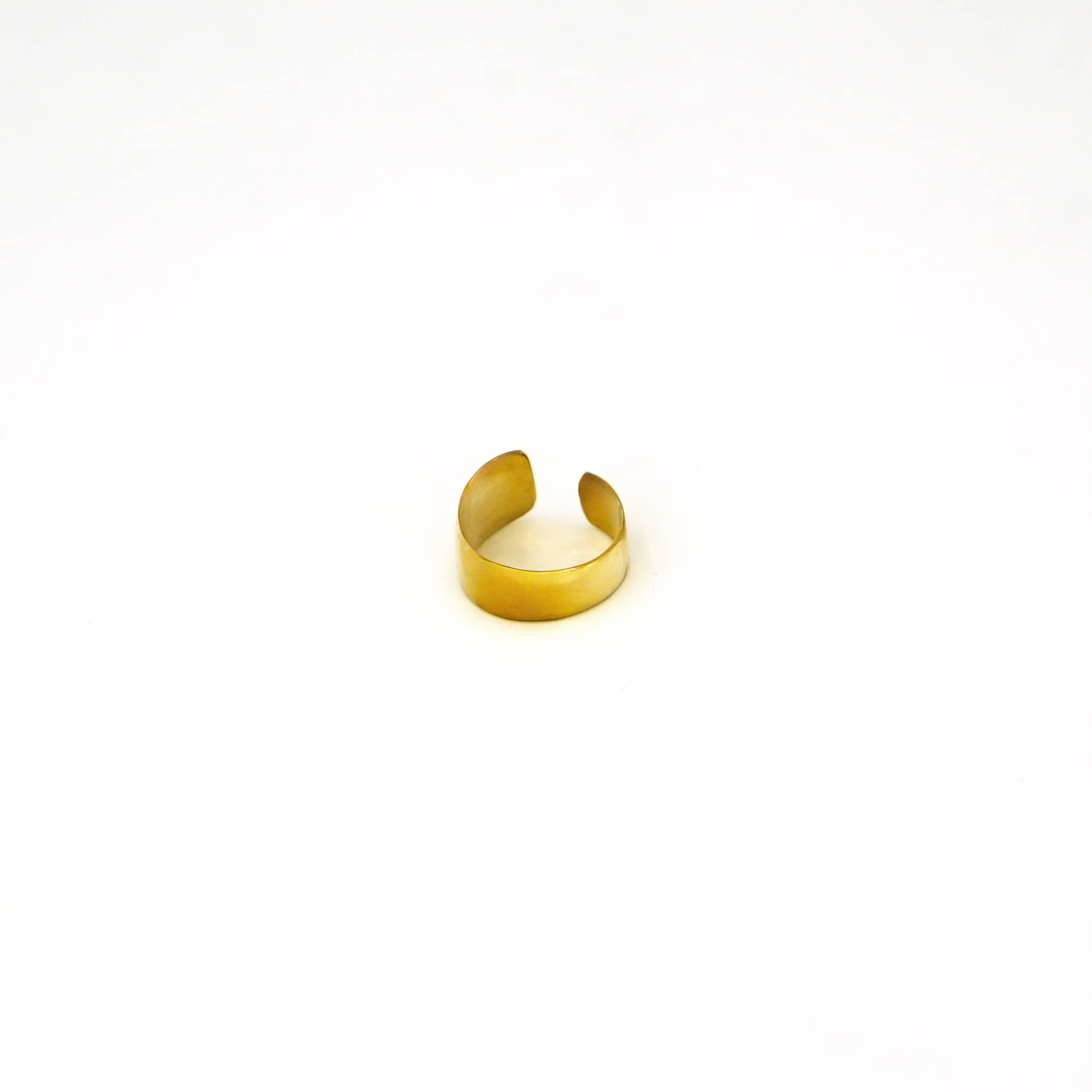 Penda adjustable wide band brass ring worn showing confident everyday fit