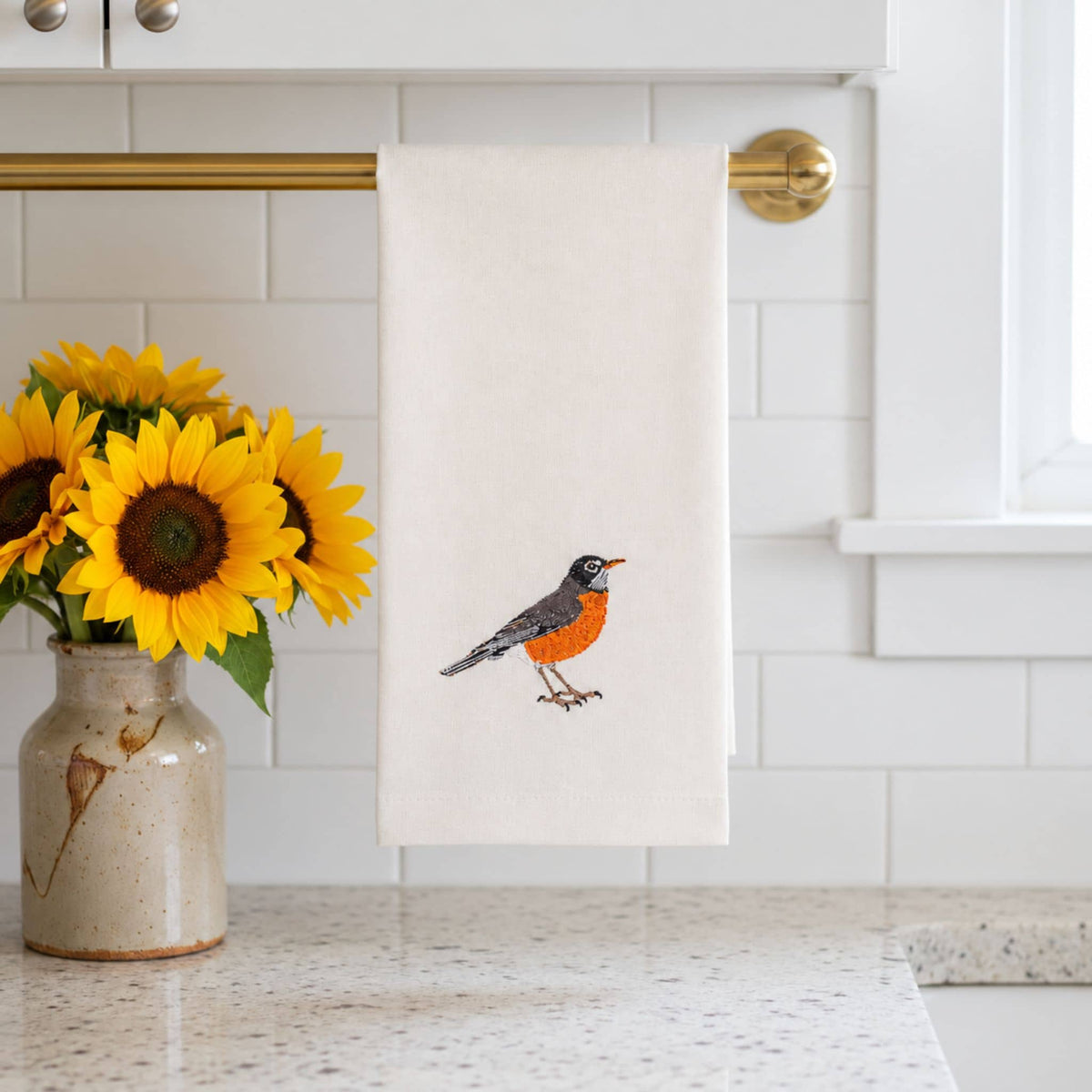 Robin bird embroidered cotton tea towel flat lay on white surface