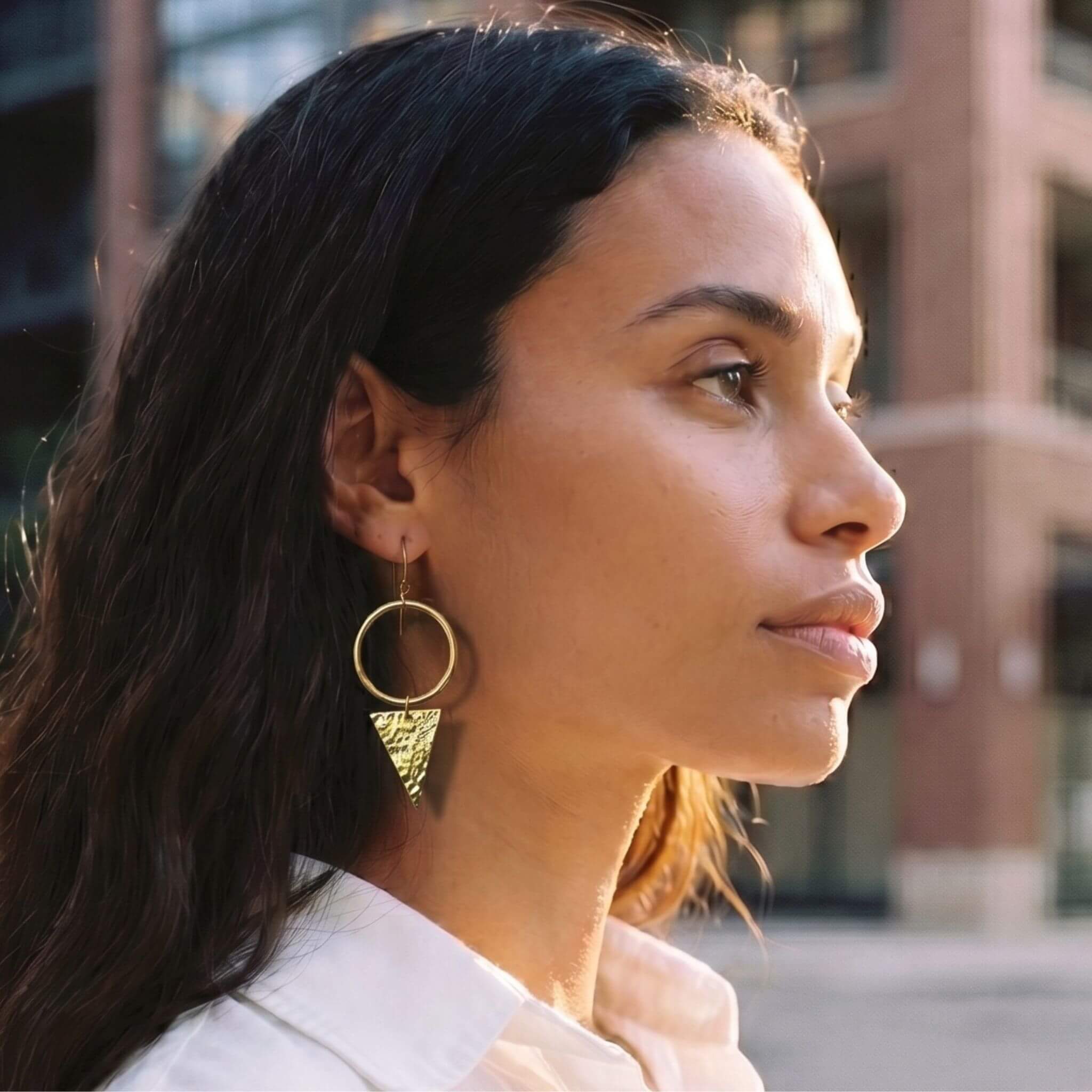 Wema circle hoop with triangle drop brass earrings worn — Ecodunia