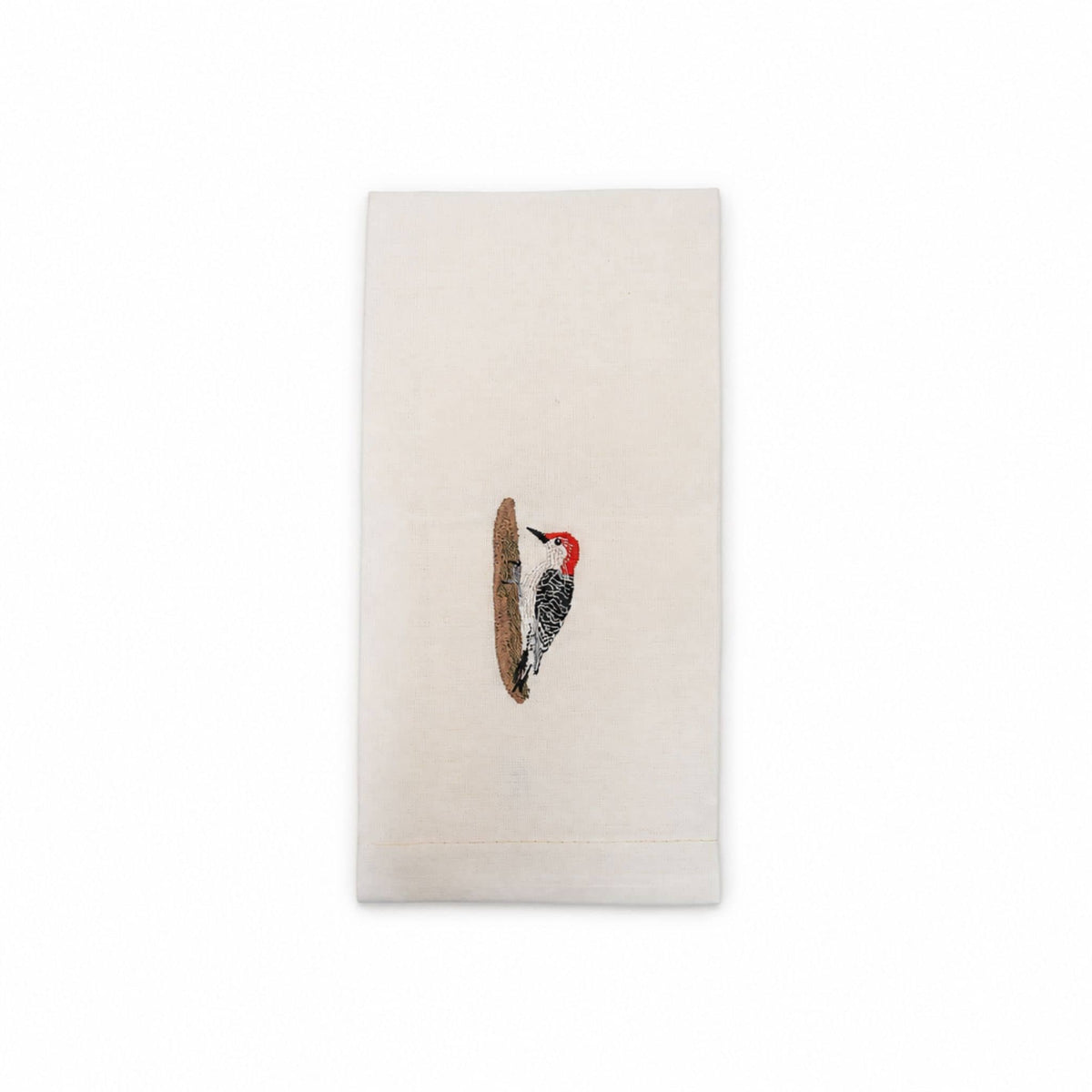Woodpecker bird embroidered cotton tea towel flat lay on white surface