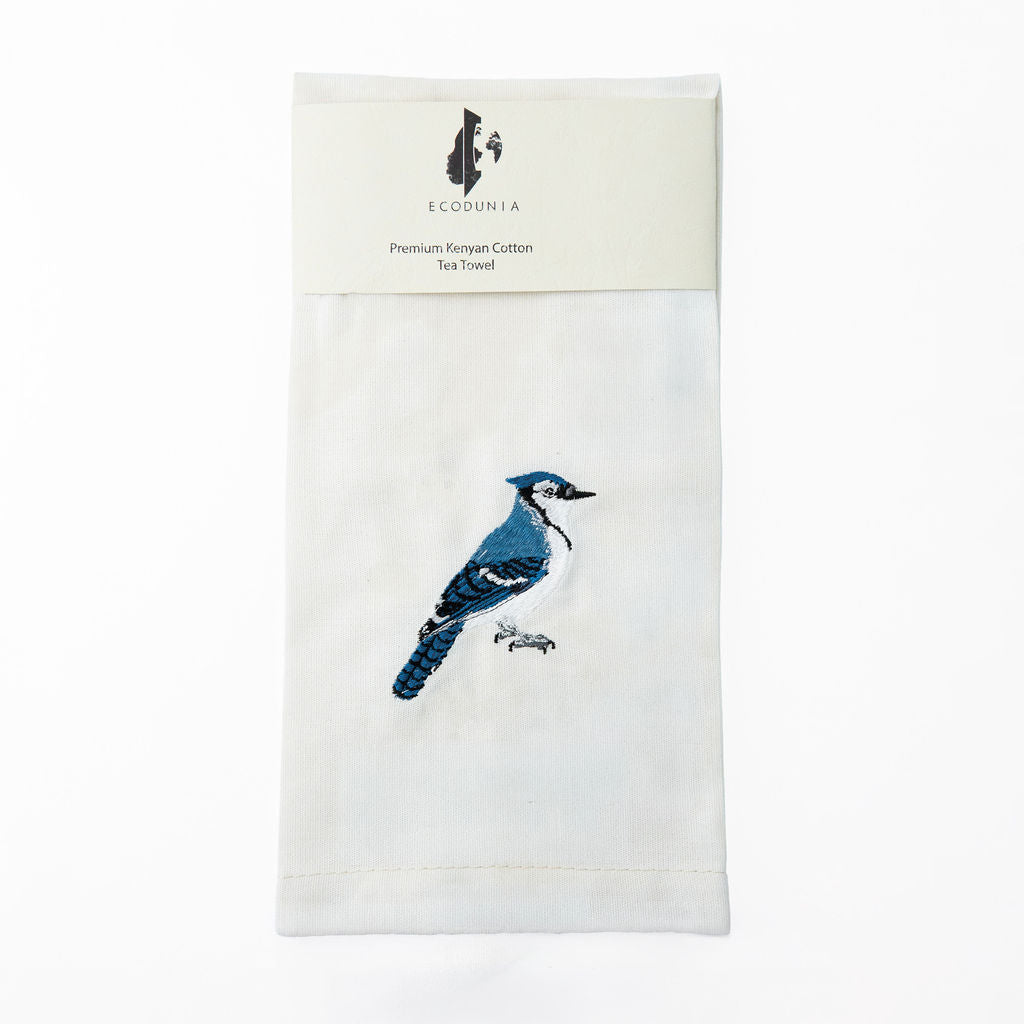 Woodpecker embroidered cotton kitchen tea towel on white surface