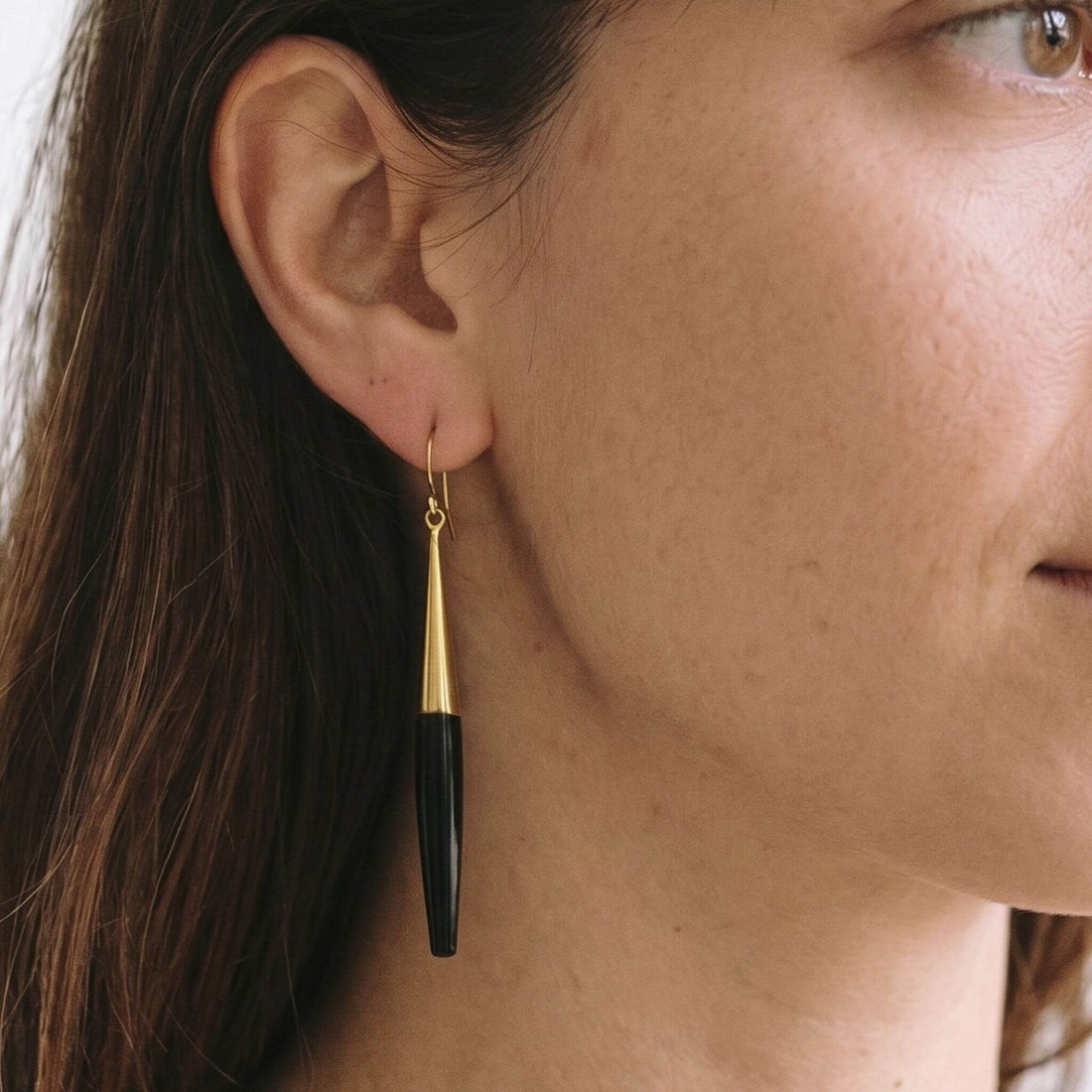 Luna brass and white horn spike drop earrings flat lay — Ecodunia 