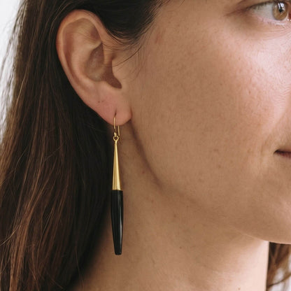 Luna brass and white horn spike drop earrings flat lay — Ecodunia 
