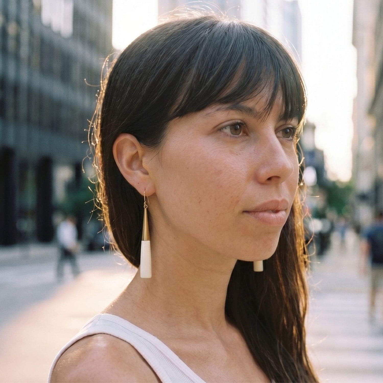 Lulu brass and white horn drop earrings flat lay — Ecodunia 