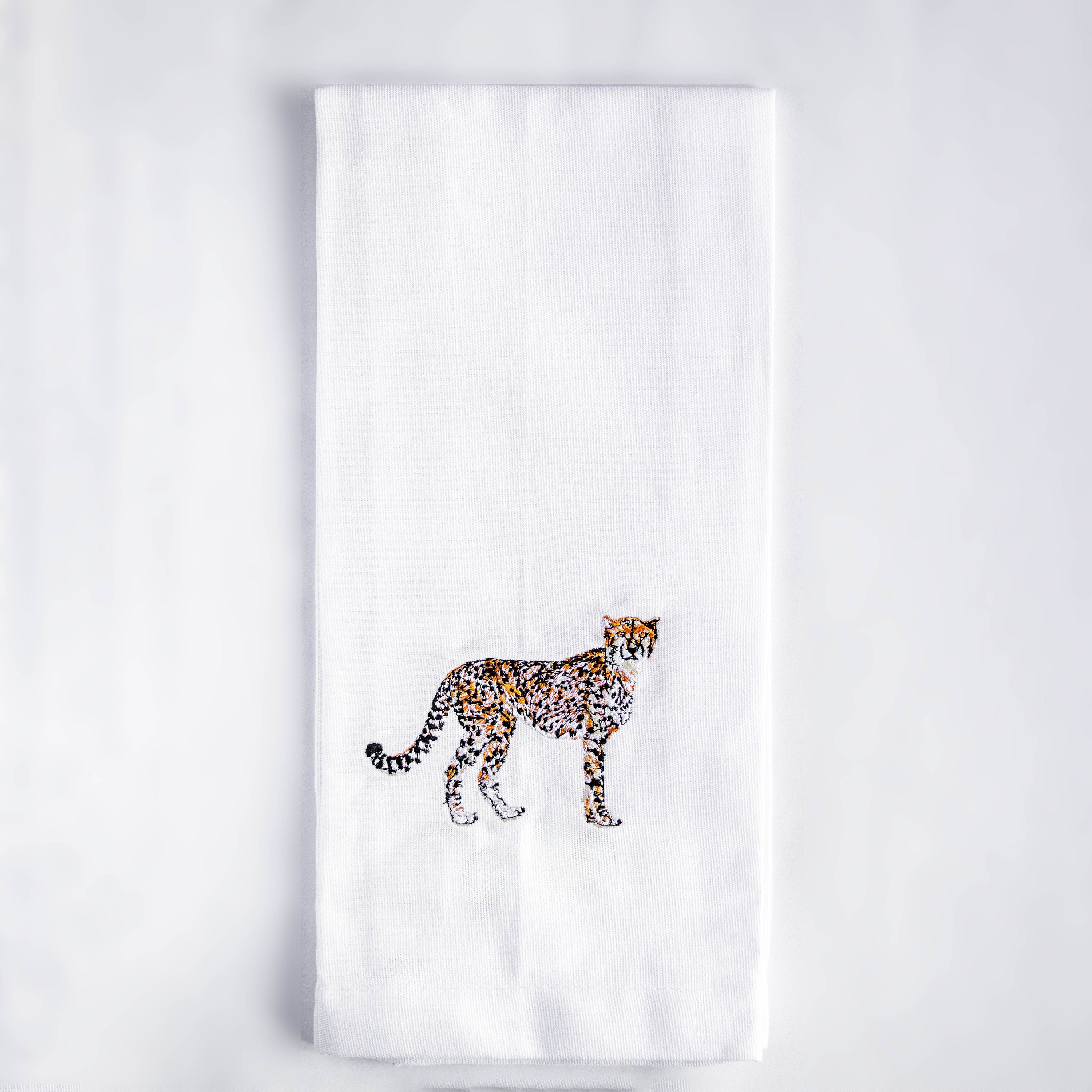 Cheetah embroidered cotton kitchen tea towel flat lay