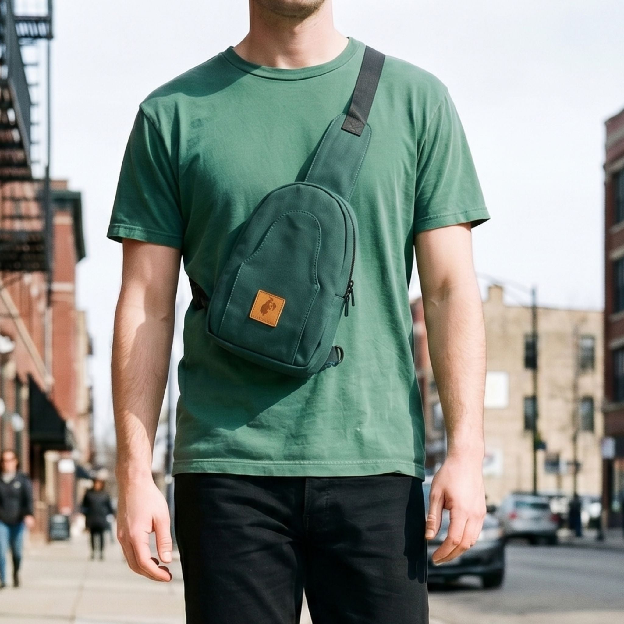 Buru canvas sling bag in forest green worn crossbody 