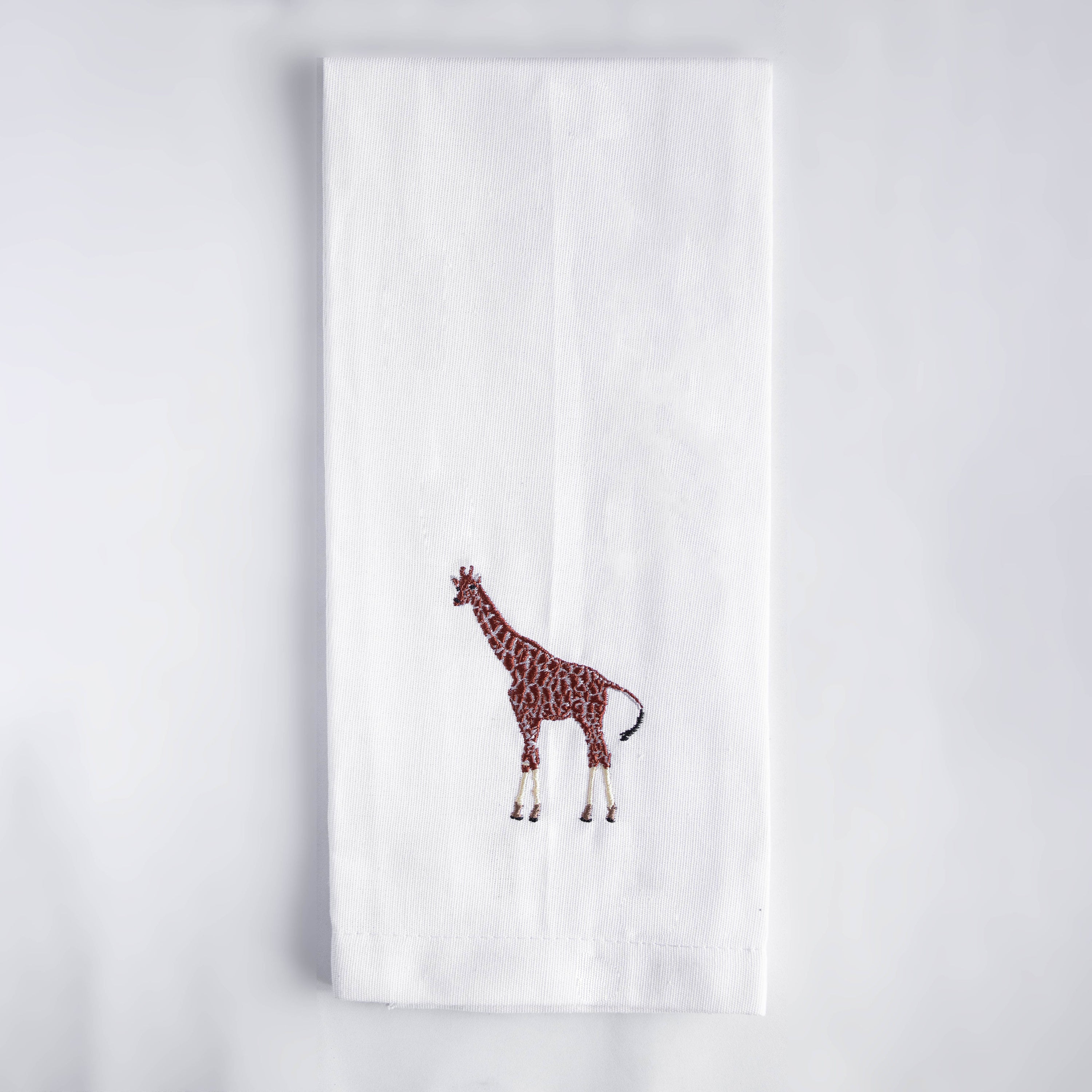 Giraffe embroidered cotton kitchen tea towel on white background