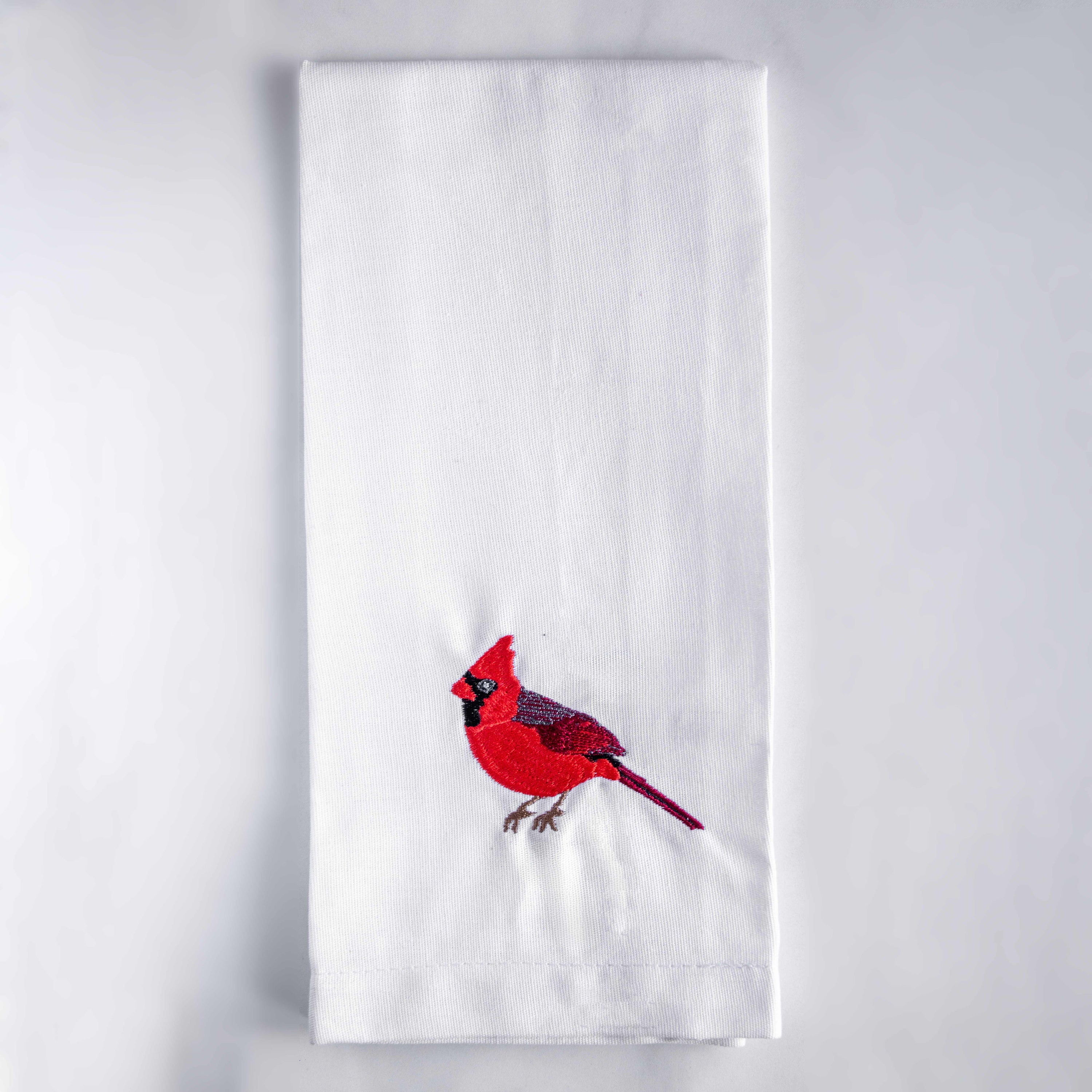 Blue Bird embroidered cotton tea towel flat lay on white surface 