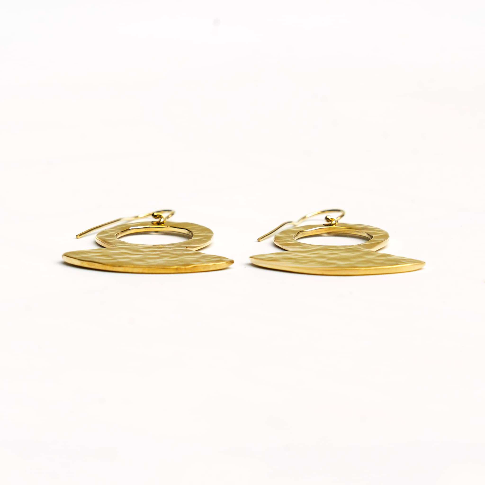 Juba hammered brass pendant earrings worn showing texture