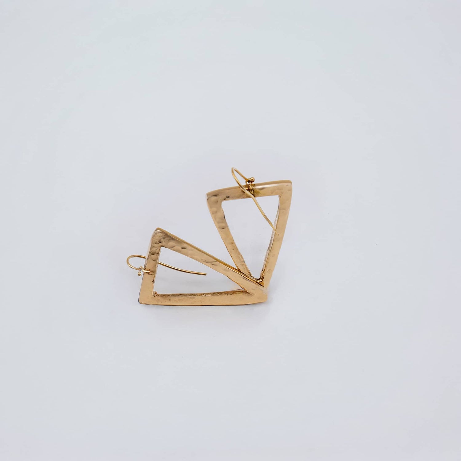 Lani hammered open triangle brass hoop earrings flat lay — Ecodunia
