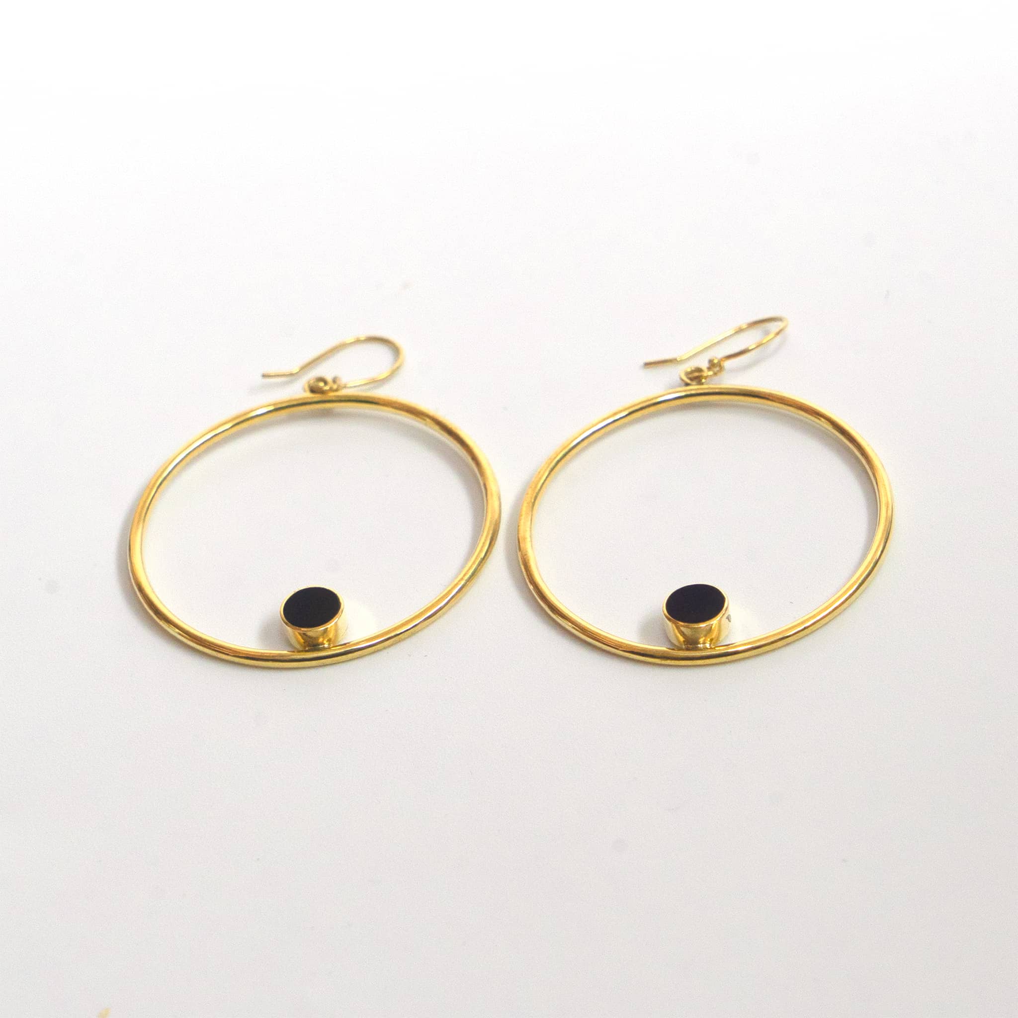 Lozi brass hoop with black horn accent earrings flat lay — Ecodunia 