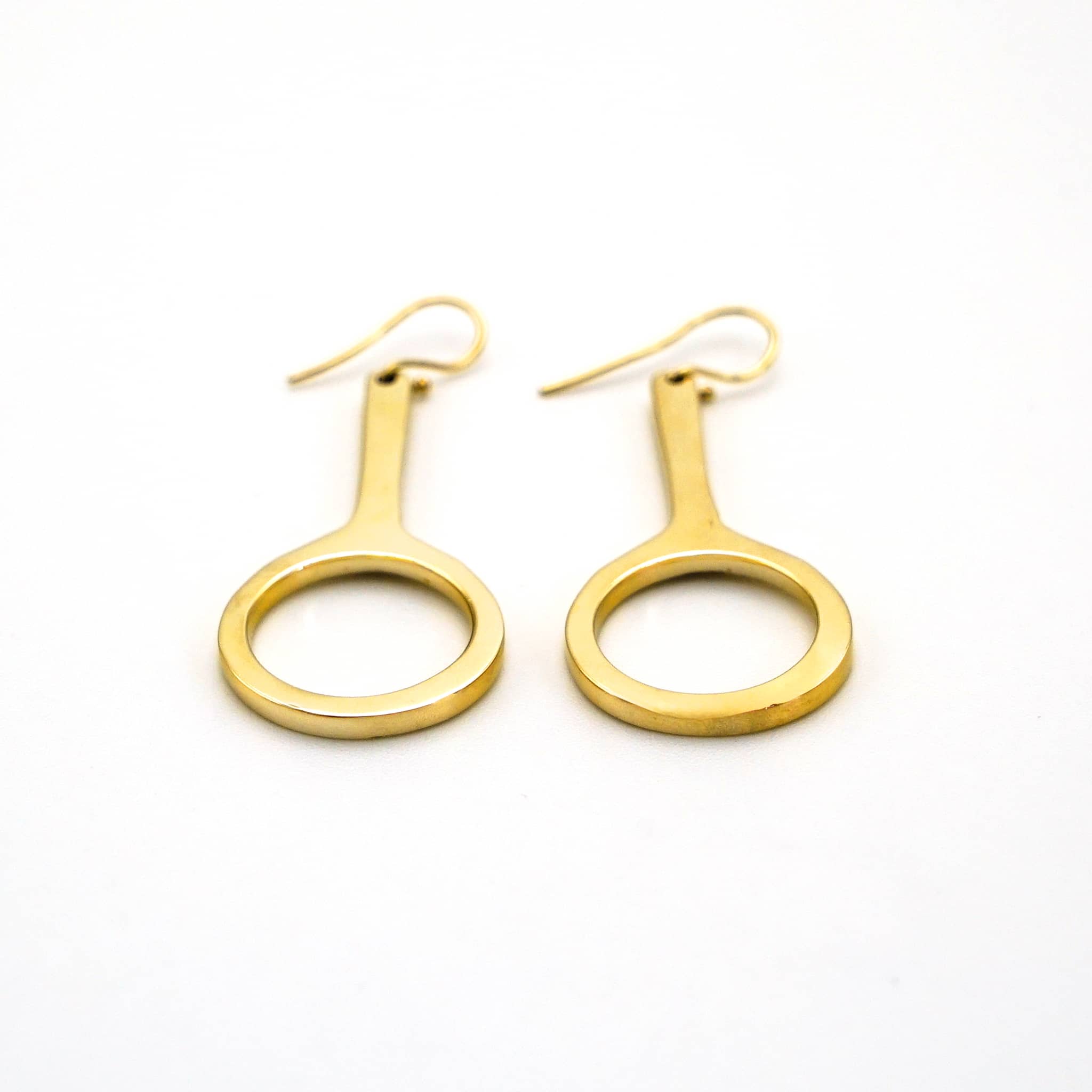 Mwenzi hoop drop brass earrings worn showing layered silhouette