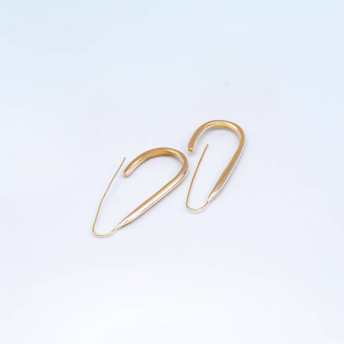 Ona open brass hoop earrings worn showing U-shape profile