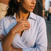 Umbo brass ring worn on hand showing two smooth symmetrical petal faces