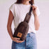 Buru plum vegan leather sling bag worn crossbody 