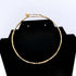 Sola sphere ball brass choker necklace flat lay on warm surface — Ecodunia