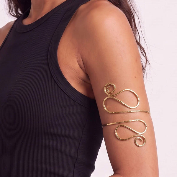 Tala hammered spiral brass armlet flat lay — Ecodunia