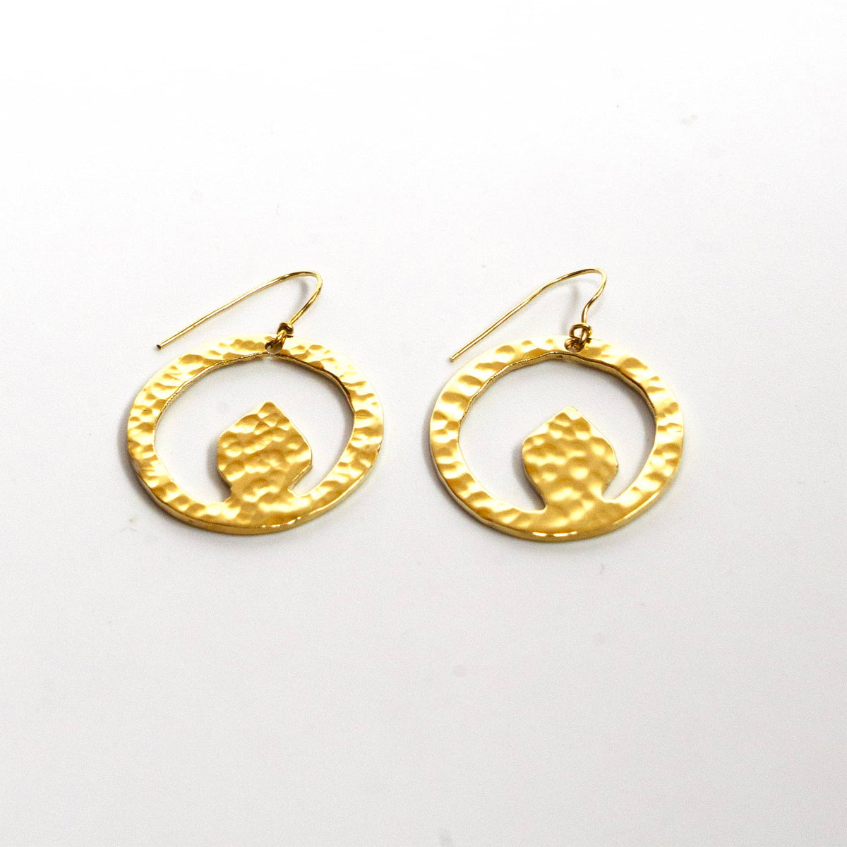 Tembo hammered irregular disc brass earrings flat lay — Ecodunia