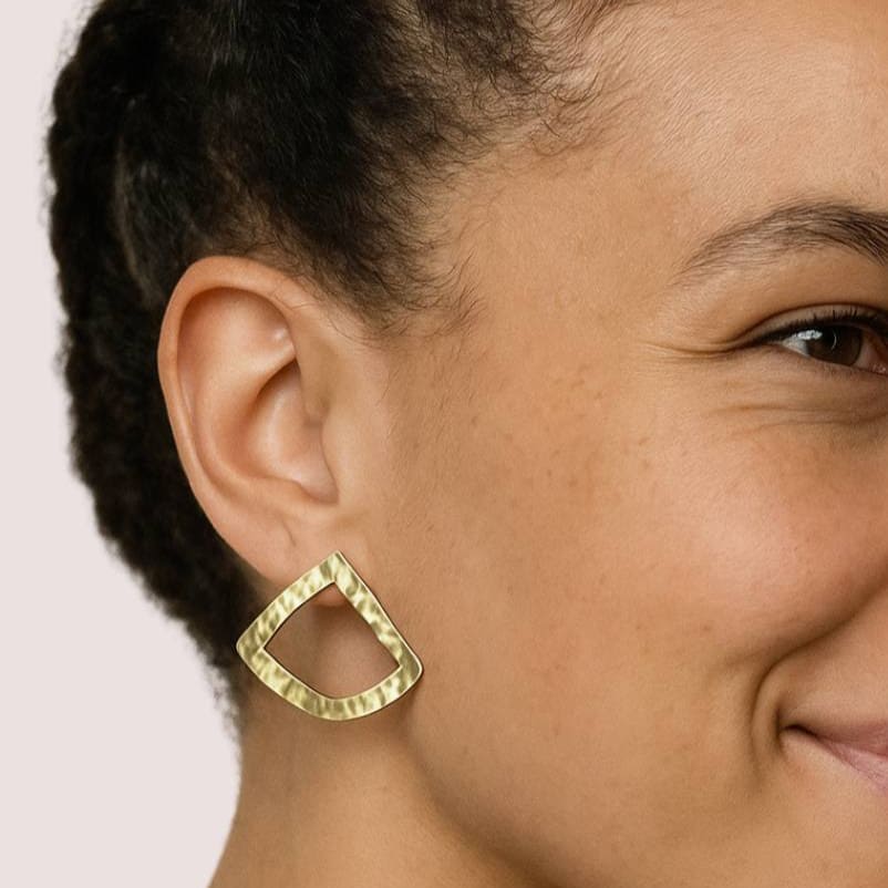 Fiti hammered open triangle brass stud earrings worn on ear — Ecodunia