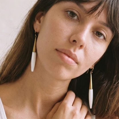 Luna brass and white horn spike drop earrings flat lay — Ecodunia 
