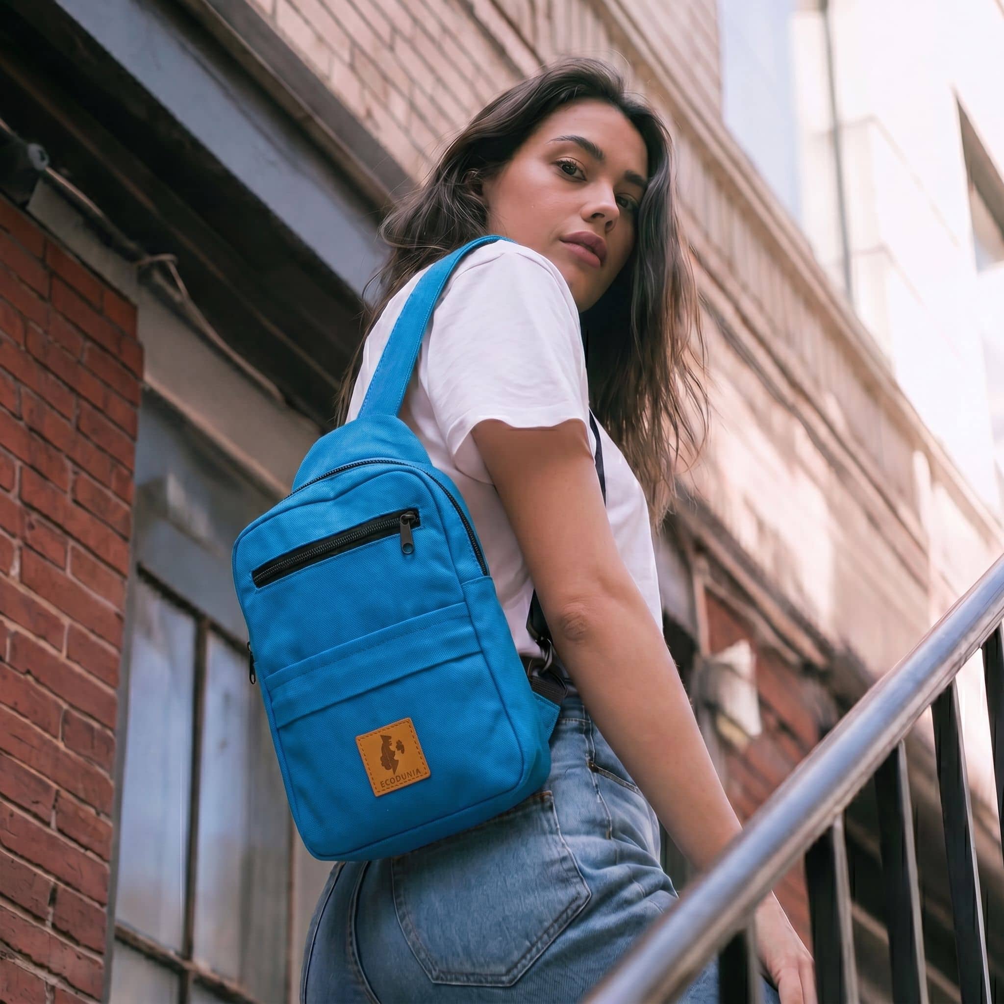 Umoja canvas sling bag in Zilly Blue worn crossbody 