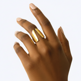 Close-up of Kiota brass ring showing two curved swept wing elements